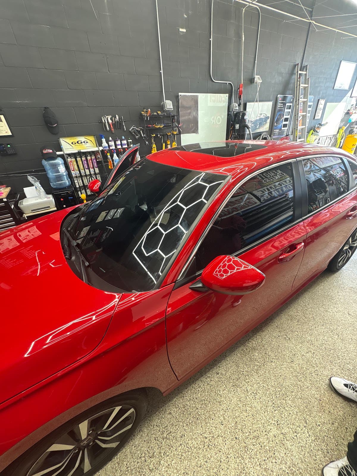Window tint installation on red sedan — Doctor Detail Eagan MN
