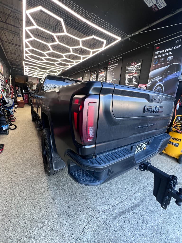 Smoked taillight tint on matte black GMC Sierra — Doctor Detail Eagan MN