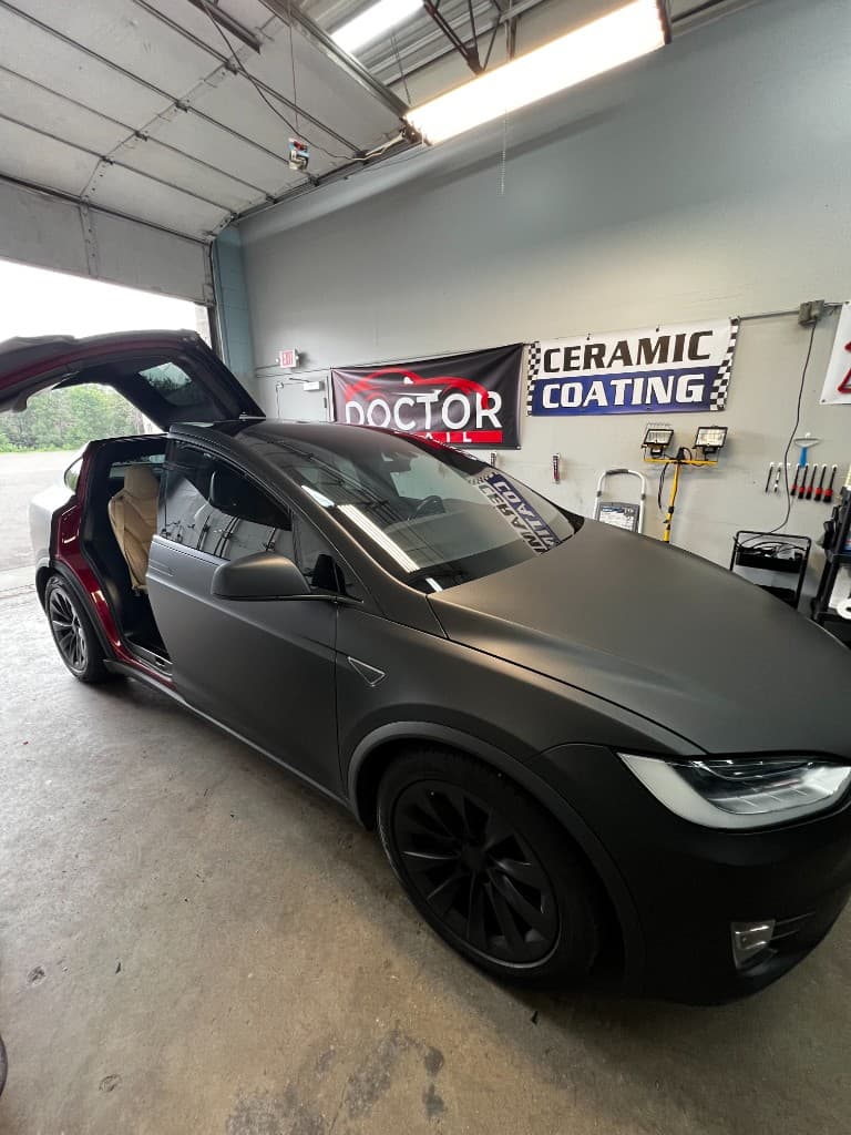 Matte black Tesla Model X with falcon door open — Doctor Detail Eagan MN