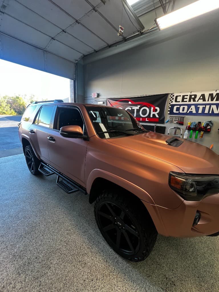 Rose gold vinyl wrap on Toyota 4Runner at Doctor Detail shop — Eagan MN
